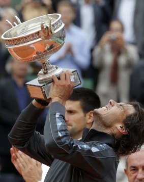 Better times: Nadal lifts the French Open trophy in 2012.