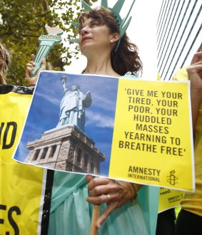 A woman dressed as the Statue of Liberty attend a protest against US President Donald Trump travel ban in Sydney in March.