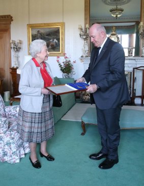 Shining knight: Cosgrove receives his knighthood from Queen Elizabeth II at Balmoral Castle in August last year. 