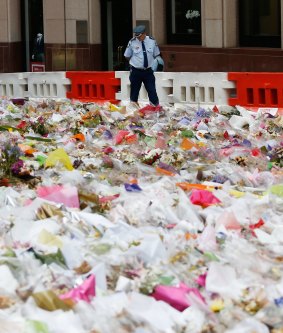 Police watched as the flowers were removed from the memorial.