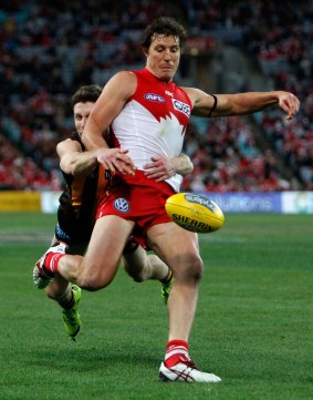 Wrapped up: Swans star Kurt Tippett is reeled in by Hawks opponent Taylor Duryea.