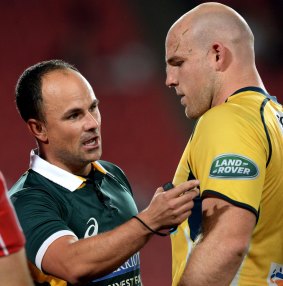 Laying down the law: Referee Jaco Peyper talks to Brumbies co-captain Stephen Moore.