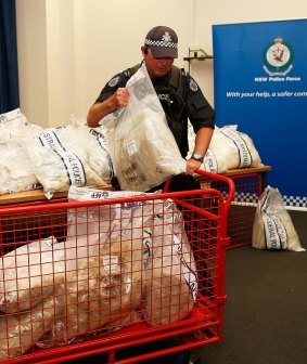 Busted: A police officer handles part of the drug seizure.