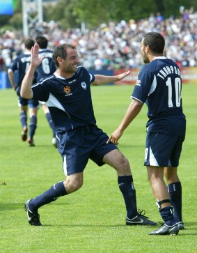 High five: Kevin Muscat and Archie Thompson celebrate during the 5-0 rout of Sydney FC at Olympic Park in 2005.