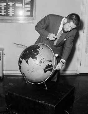 Professor Harry Messel pictured at Sydney University on 15 October 1957 with a working model of Russia's Sputnik. 