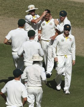 Off the mark: The Australians celebrate Steve O'Keefe's first Test wicket against Pakistan.