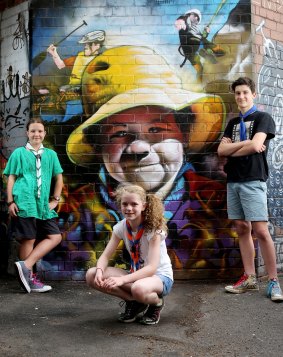 From left, Scouts Matilda, Tamsin and Sam in Stevensons Lane with the street art that will form part of a 'wide game' on Sunday.