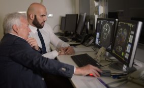 Professor Perry Bartlett and Aiman Alnajjar looking at MRI scans.