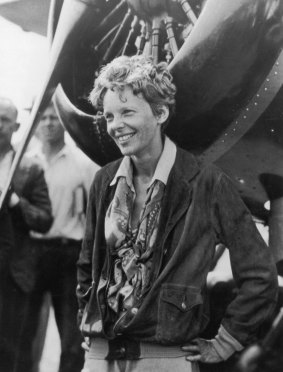 American aviatrix Amelia Earhart (1898 - 1937) exits her aircraft at Derry, Ireland, after her solo transatlantic flight, 1932.