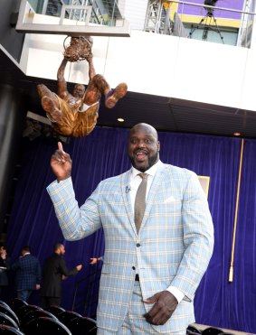 Immortalised: Former Los Angeles Lakers player Shaquille O'Neal poses in front of his statue.