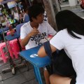 Lunch time: People eat noodles at a street food stall on Thonglor road, Bangkok, Thailand. Officials see street food as an illegal nuisance.