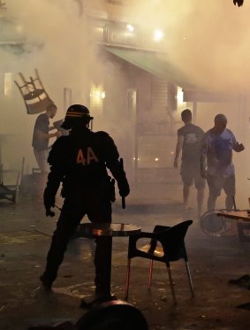 A chair flies through the air during clashes between police and England supporters in downtown Marseille, France.