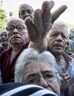 Pensioners queue outside an Athens bank on Wednesday when they were allowed to withdraw a small part of their benefits.