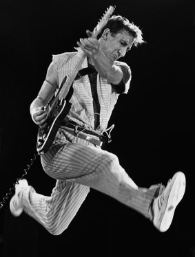 Guitarist and creative genius behind The Who, Pete Townshend, performs his signature leap during one of the legendary rock band's final 1982 concerts held at New York's Shea Stadium.