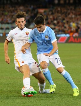 Alessandro Florenzi of AS Roma tackles Manu Garcia of Manchester City.