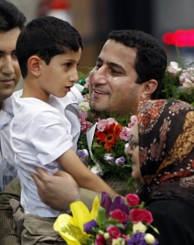 Shahram Amiri greets his son Amir Hossein after arriving back in Iran in July 2010.