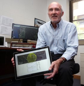 Prof George Milne with this bushfire tracking device.