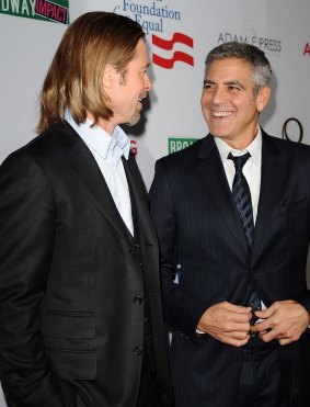 Brad Pitt and George Clooney attend the west coast premiere of "8" at The Wilshire Ebell Theatre on March 3, 2012 in Los Angeles, California.