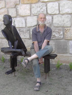 John Clegg posing with one of his own sculptures.