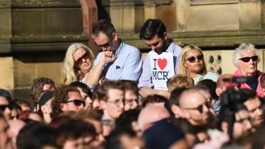 Crowds gather in Manchester to pay tribute to the victims.