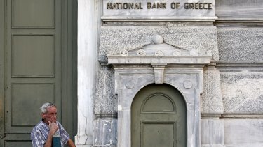 A pensioner waits to receive part of his pension in Athens on Tuesday.
