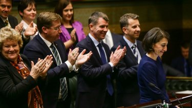 NSW Premier Mike Baird and the front bench applaud at the conclusion of Treasurer Gladys Berejiklian's budget speech at State Parliament.
