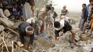 Yemenis search for survivors in the rubble of houses destroyed by Saudi-led air strikes in a village near Sanaa on Saturday. 