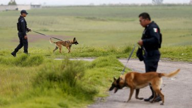 Policemen patrol with dogs near Altiplano Federal Penitentiary on Tuesday. 