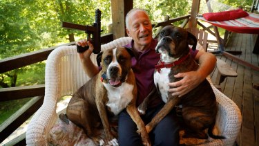Richard Feldman at his home in Rindge, New Hampshire with his dogs Stanley and Stella and a version of the TEC-9.