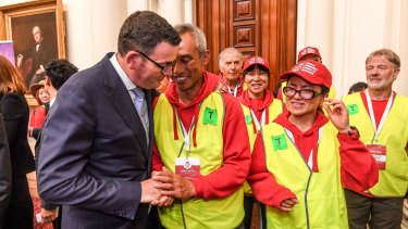 Premier Daniel Andrews with one of the walk organisers, Charles Zhang, after the apology.