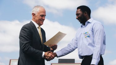 Prime Minister Malcolm Turnbull welcomes a new citizen at an Australia Day ceremony.