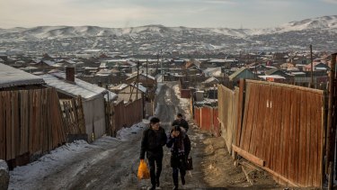 Residents walk through one of the so-called ger districts in Ulaanbaatar. According to government figures, around 80 per cent of the capital's air pollution is produced by people living in the districts.