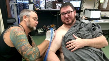 George Christensen is given his Coptic Madonna tattoo by Dave Phare from Mad Monk Tattoos in Mackay. 
