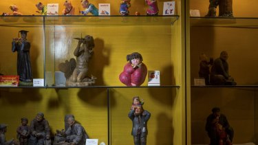 A traditional clay figurine of a chubby peasant girl in a red smock, at the centre of the Chinese government?s "China Dream" campaign, sits among other figures in a showroom in Tianjin.