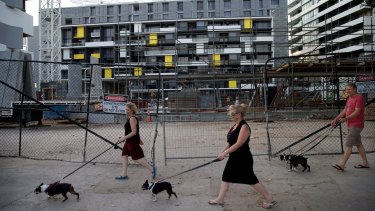 Zetland residents walk past a Green Square development earlier this year. 