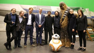 Royal visit ... from left, Mark Hamill (Luke Skywalker), director Rian Johnson, Prince Harry, Prince William and British actor John Boyega (centre) pose with Chewbacca and British actress Daisy Ridley at Pinewood Studios.