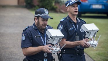 Police monitor aerial images captured by a drone in Queensland.