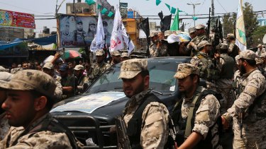 Hamas militants  carry the body of their colleague of Nidal al-Jaafari during his funeral in Rafah refugee camp, Gaza Strip.