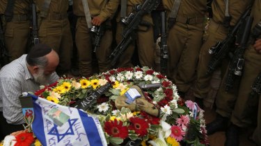 Israeli soldiers at the grave of Hadar Goldin during his funeral in Kfar Saba on August 3.