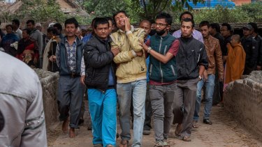 Relatives of a victim of the earthquake that hit Nepal cry while walking to the cremation site in Bhaktapur, Nepal.