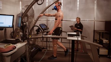 Grant Lynch (on the treadmill) with Georgia Chaseling - two PhD Students working at the  University of Sydney's special room that simulates heatwaves.