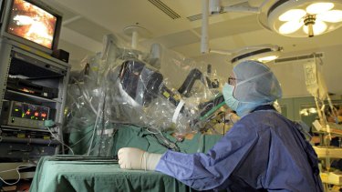 A surgeon performing robotic surgery.