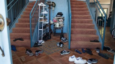 Shoes in the foyer of one of many properties rented by Frank Lin and turned into boarding houses for Taiwanese nationals who are working at the nearby Thomas Foods plant. 