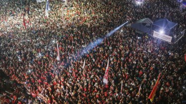 Anti-impeachment protesters attend a rally in Rio while former president Lula speaks.