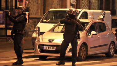 Police officers take up positions in Saint-Denis, a northern suburb of Paris on Wednesday.