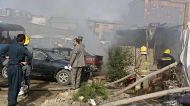 Afghan security forces investigate the site of a bomb blast in Kabul.