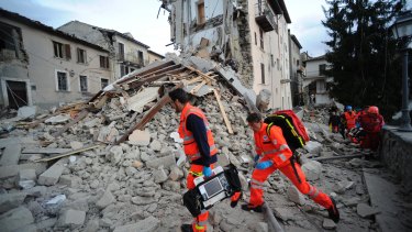 Rescuers search the ruins of a building in Arquata del Tronto, central Italy.