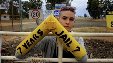 A protester locks on to a gate that is part of Santos' Narrabri CSG project.