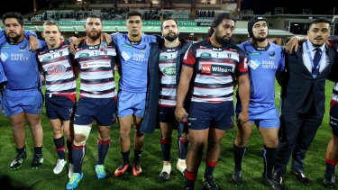 In the firing line: Force and Rebels players provide a show of unity following their final game of the Super Rugby season. One team will go. But is that enough?