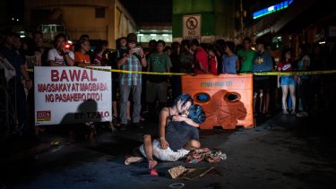 Jennilyn Olayres cradling the body of her husband Michael Siaron after he was shot by vigilantes, a photo that has sharply divided Filipinos.